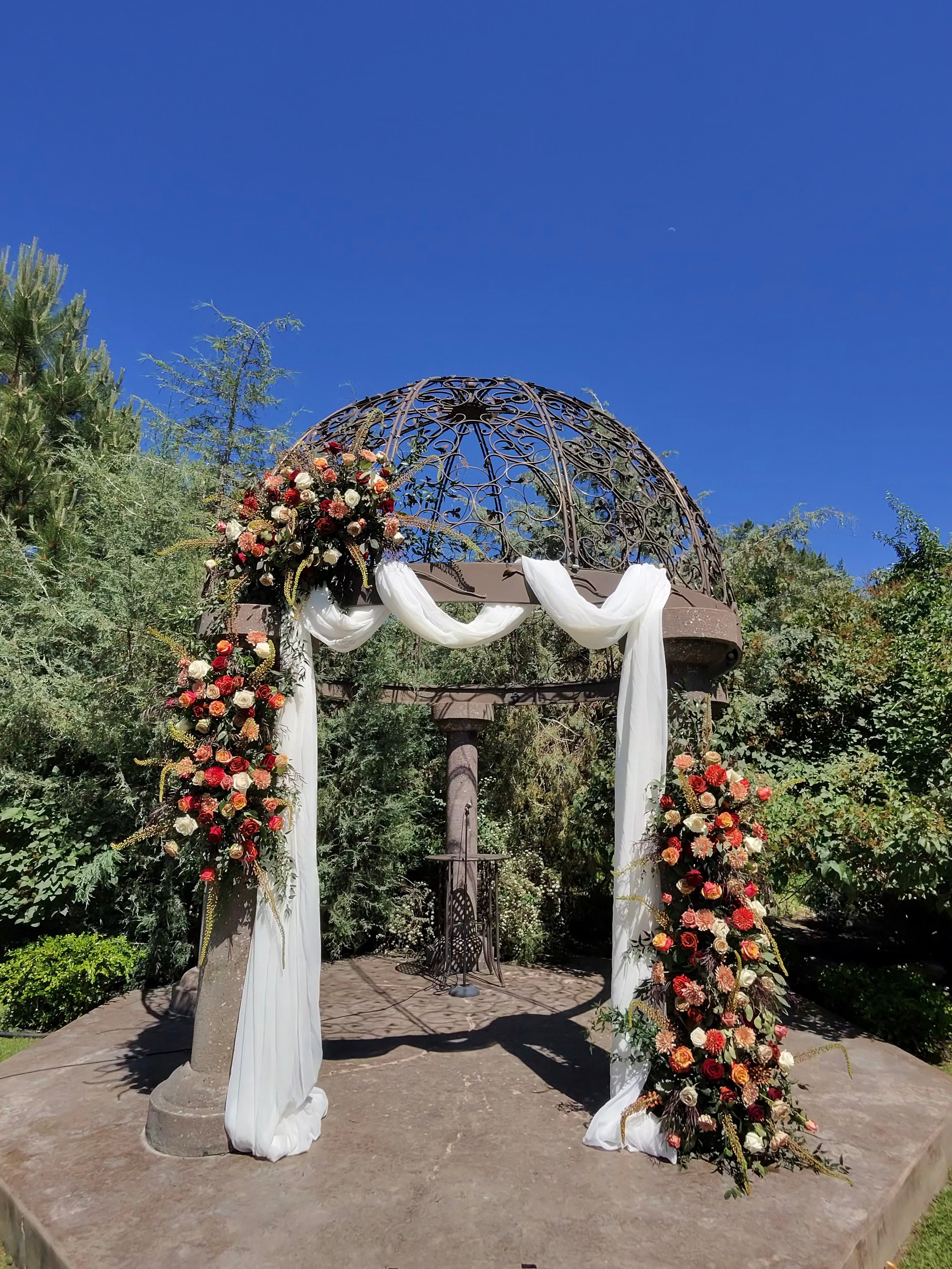 Outdoor ceremony arch with greenery
