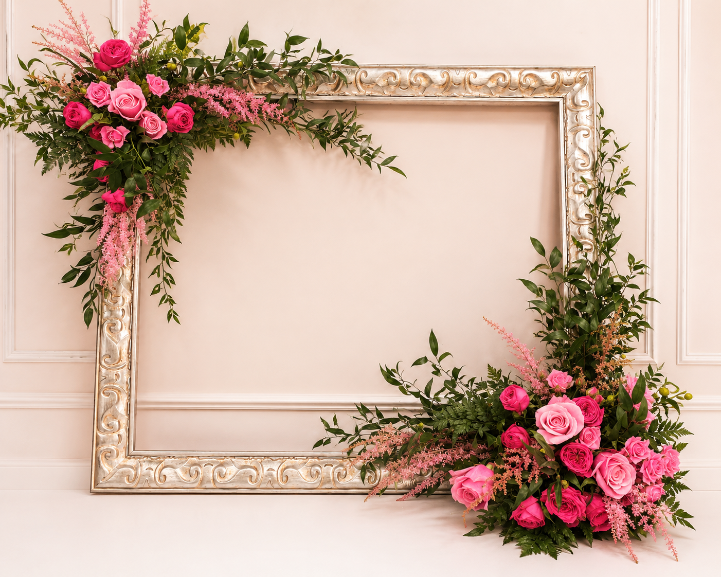 Ornate silver frame decorated with pink roses, hot pink roses, and cascading greenery